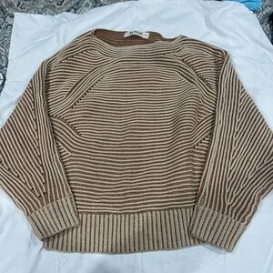 Striped sweater oversized body into arms.